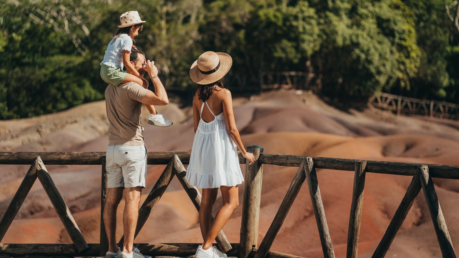 Family exploring the Seven Coloured Earth in Chamarel, Mauritius, a unique natural geological site