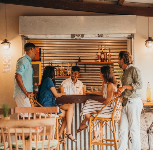 A group of people enjoying drinks at a bar in Kaz'alala, Mauritius.
