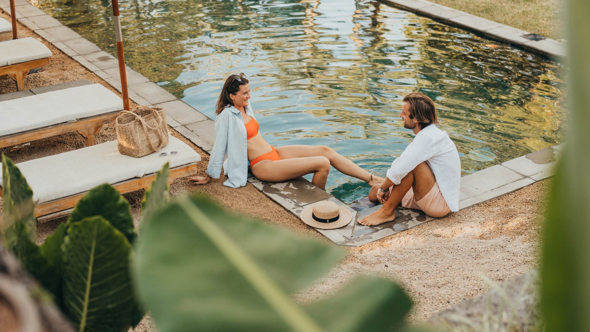 Couple relaxing by the pool at a luxurious resort.