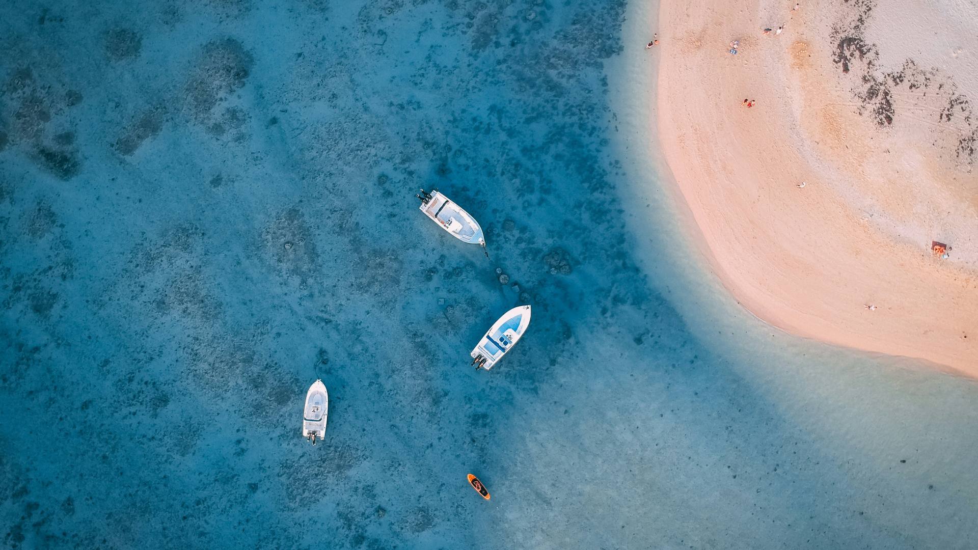 Aerial view of boats floating in the blue lagoon at Bel Ombre, Mauritius.